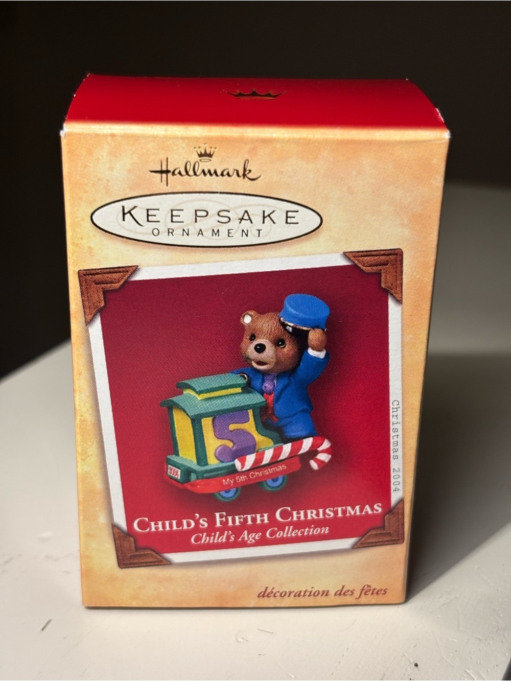 Hallmark Brown Bear Ornament with Blue Outfit and Red Background